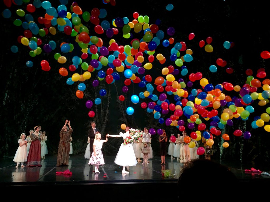 Photo of balloons falling on actors at the end of a stage play, to show how beauty can be captured in a moment