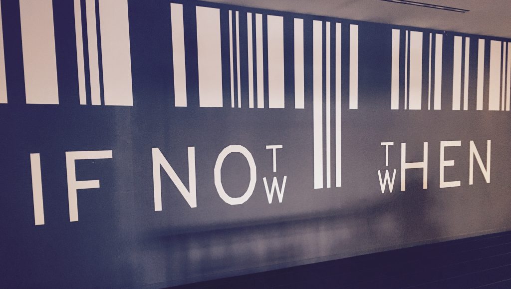 Photo of a wall art that says "if not now, then when?" to pose the same question to the reader.