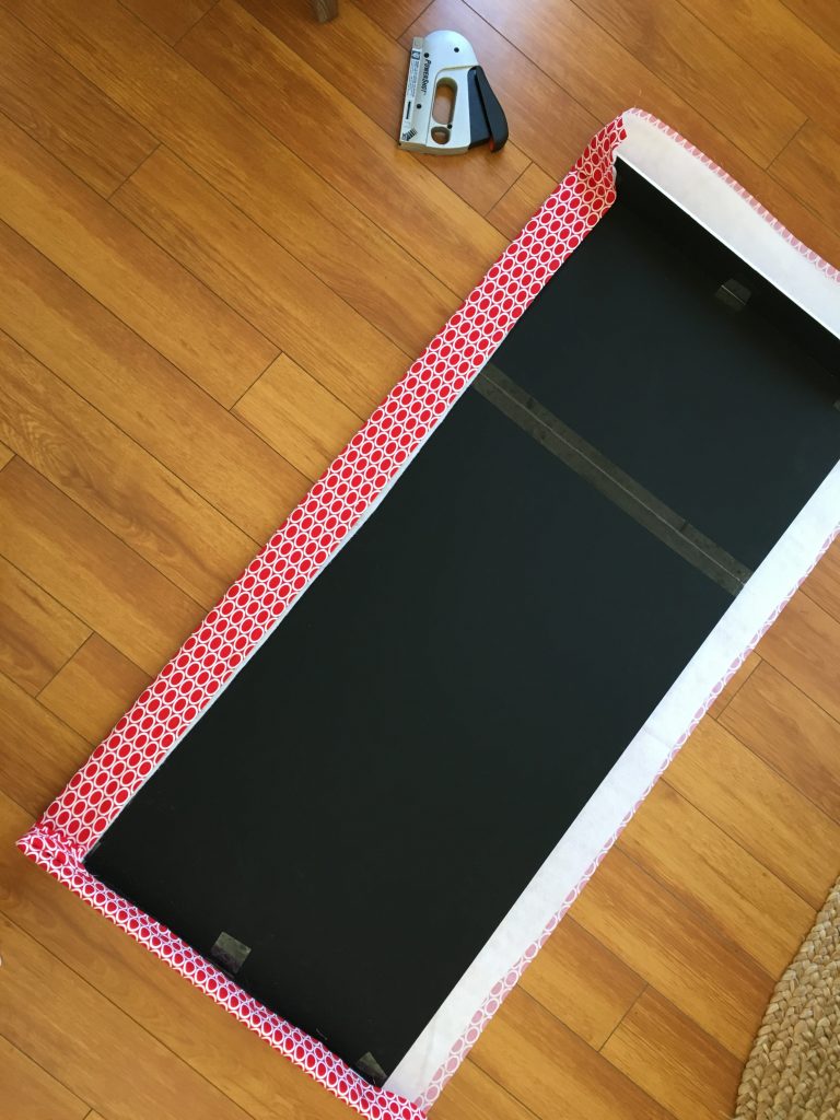 The back of the window cornice, showing how to staple gun fabric to the backing