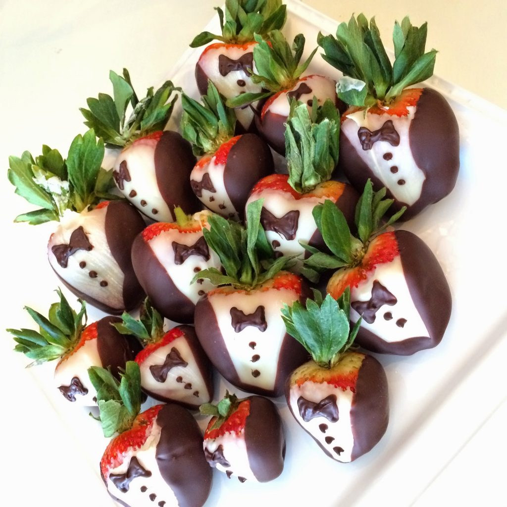 Photo of strawberries covered in chocolate and frosted to look like they are wearing tuxedos